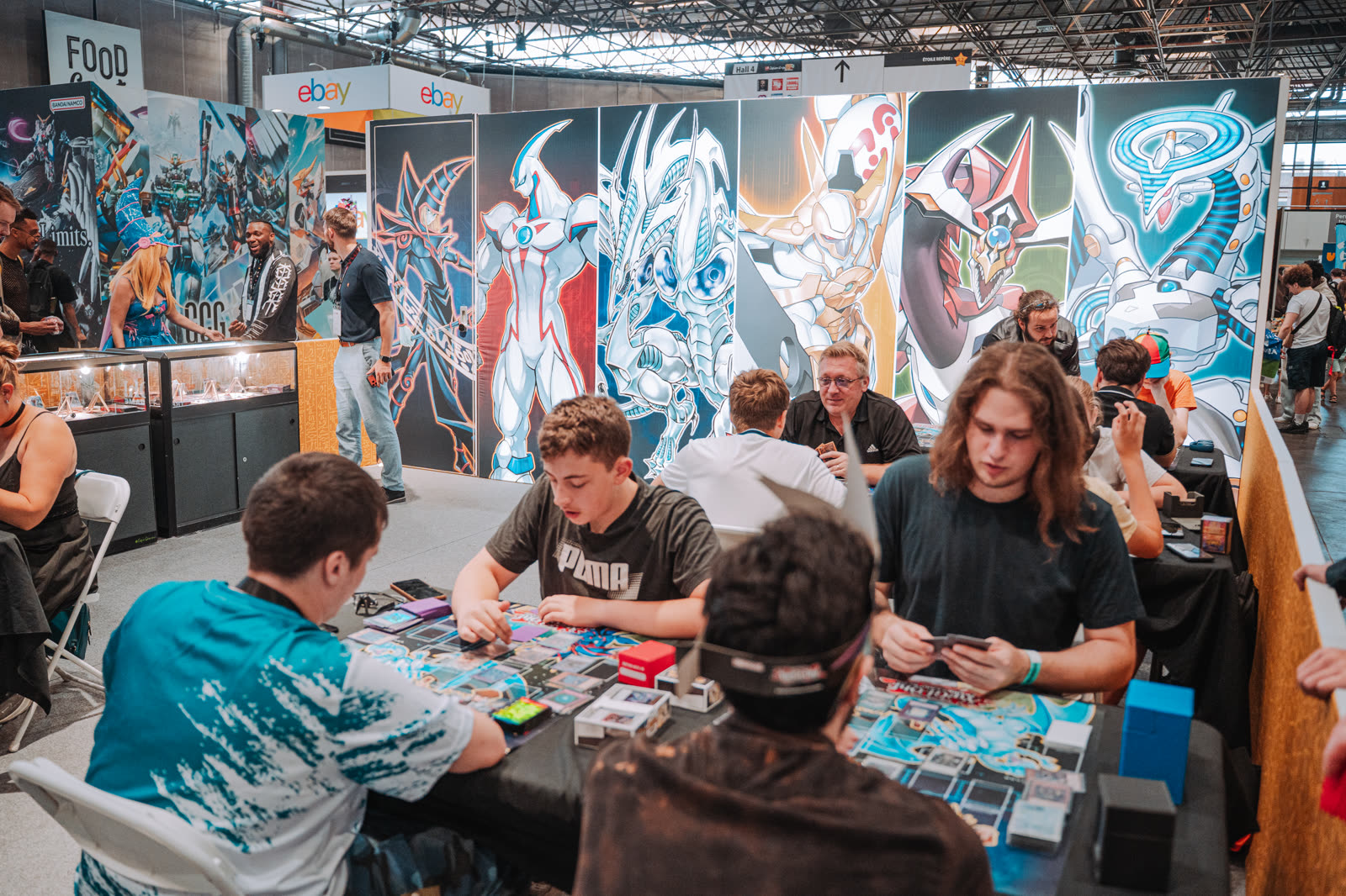 Players mid-game on the TCG Universe play area